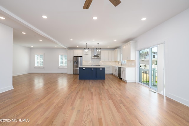 128 Church St, Keyport, NJ 07735 - unfurnished living room with healthy amount of natural light, recessed lighting, ceiling fan, and light wood-style floors