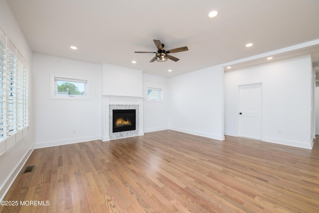 128 Church St, Keyport, NJ 07735 - unfurnished living room with ceiling fan, plenty of natural light, light wood-style flooring, a lit fireplace, and recessed lighting