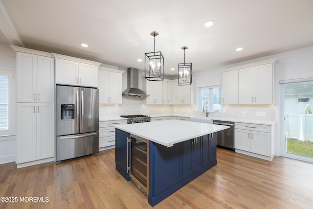 128 Church St, Keyport, NJ 07735 - kitchen with stainless steel appliances, wall chimney range hood, wine cooler, white cabinets, and a center island