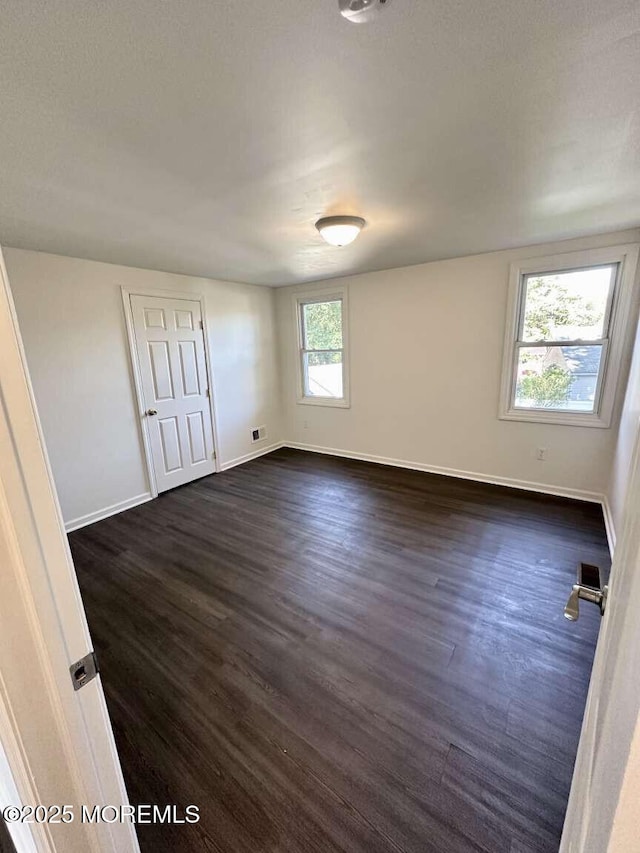 267 State Route 36, Hazlet, NJ 07730 - spare room with baseboards and dark wood-style flooring