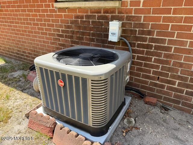 details featuring brick siding and central AC