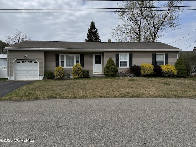 single story home with a garage, entry steps, driveway, and a front yard