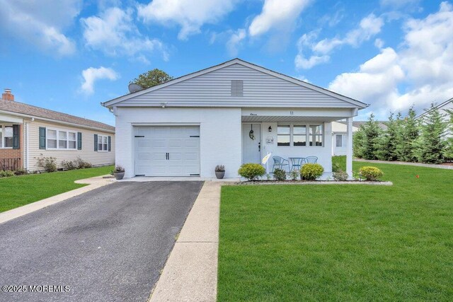 ranch-style home with a porch, a garage, a front lawn, and driveway