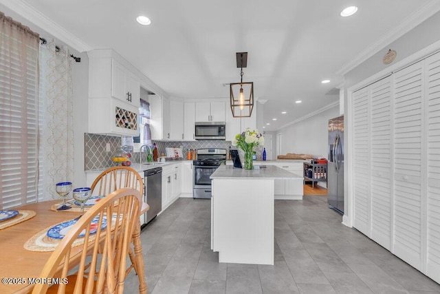 kitchen featuring light countertops, recessed lighting, appliances with stainless steel finishes, and decorative backsplash
