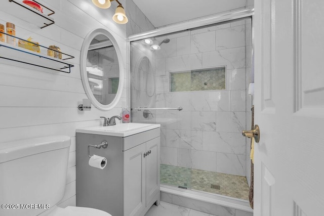 bathroom featuring toilet, a shower stall, marble finish floor, and vanity