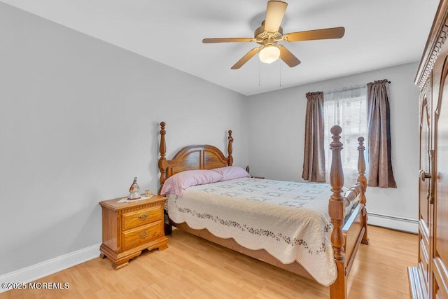 bedroom featuring baseboards, ceiling fan, baseboard heating, and light wood-type flooring