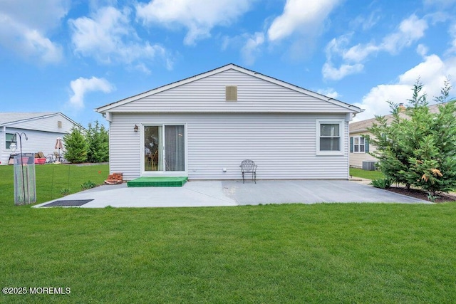 back of property with a patio area, central air condition unit, and a yard