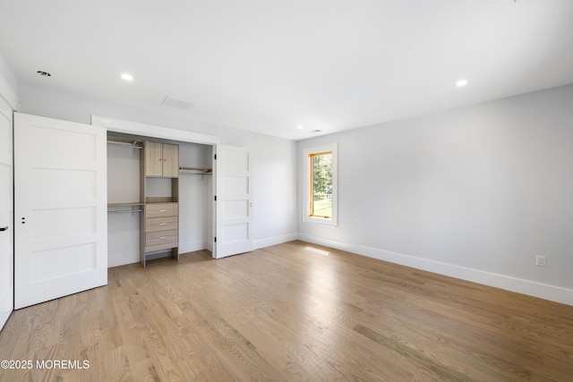 unfurnished bedroom featuring recessed lighting, baseboards, light wood-style floors, and a closet