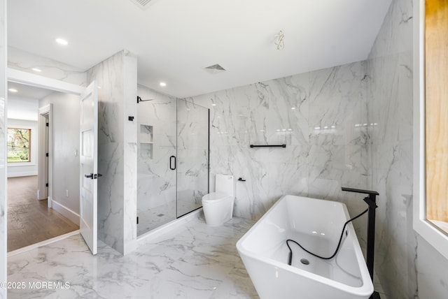 full bathroom featuring a marble finish shower, toilet, recessed lighting, a freestanding tub, and marble finish floor