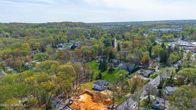 drone / aerial view featuring a wooded view