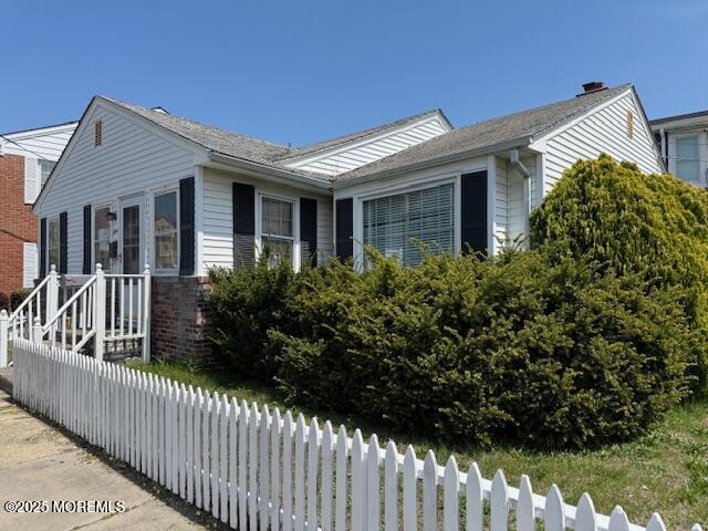 view of side of home featuring fence