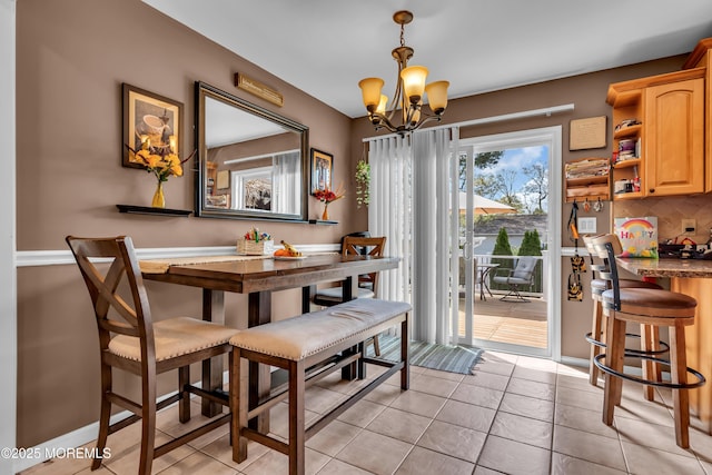 1915 Red Cedar St, Toms River, NJ 08753 - dining area with light tile patterned flooring, a notable chandelier, and baseboards
