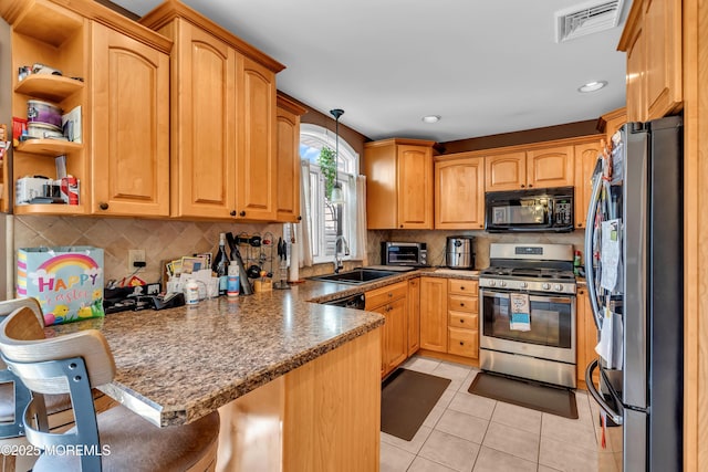 1915 Red Cedar St, Toms River, NJ 08753 - kitchen with light tile patterned floors, appliances with stainless steel finishes, a sink, visible vents, and a peninsula