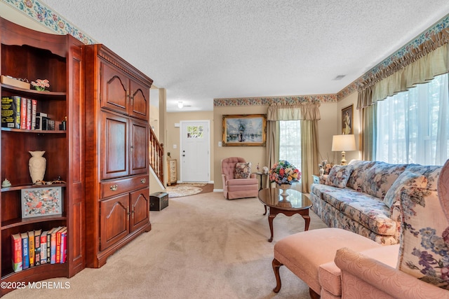 44 Sacramento Way, Tinton Falls, NJ 07712 - living room featuring light carpet, a textured ceiling, and stairway