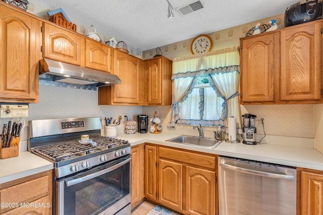 44 Sacramento Way, Tinton Falls, NJ 07712 - kitchen featuring stainless steel appliances, extractor fan, a textured ceiling, light countertops, and wallpapered walls