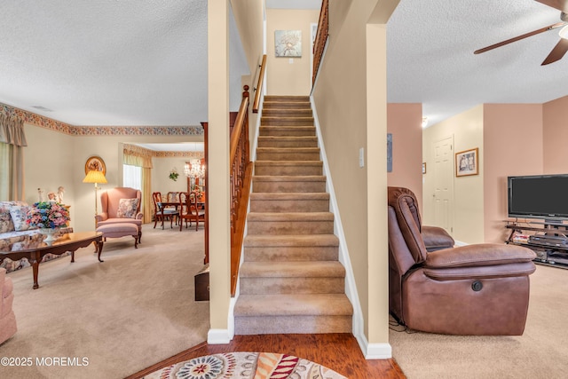 44 Sacramento Way, Tinton Falls, NJ 07712 - stairs with a textured ceiling, a ceiling fan, carpet, a chandelier, and wood finished floors