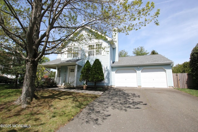 44 Sacramento Way, Tinton Falls, NJ 07712 - traditional home with driveway, a garage, covered porch, and a chimney