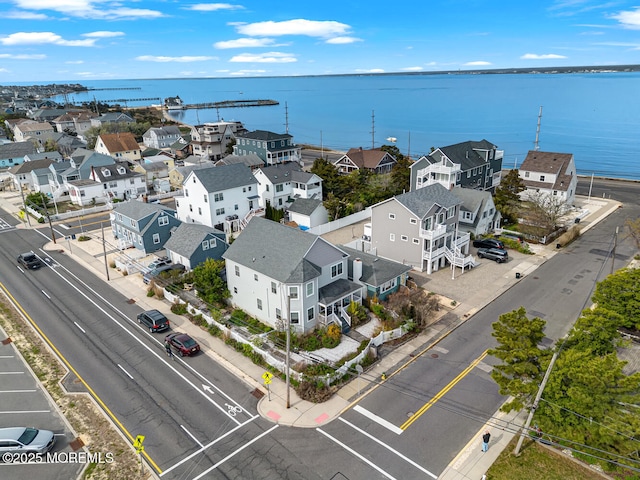 birds eye view of property with a water view and a residential view