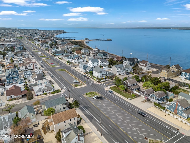 drone / aerial view with a water view and a residential view