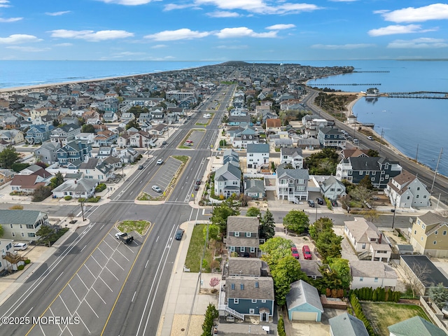 drone / aerial view featuring a water view and a residential view