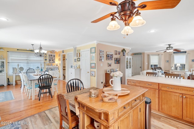dining room featuring recessed lighting, ornamental molding, ceiling fan with notable chandelier, and light wood-type flooring