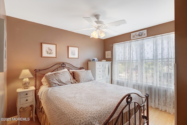 bedroom with ceiling fan and light wood-type flooring