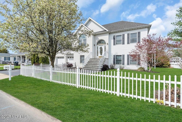 raised ranch with a fenced front yard and a front yard