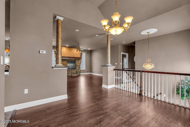 interior space with a fireplace, ceiling fan with notable chandelier, recessed lighting, baseboards, and wood finished floors