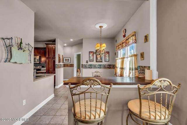 dining space with light tile patterned flooring and a chandelier