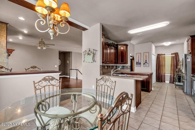 dining area featuring ceiling fan with notable chandelier, recessed lighting, baseboards, light tile patterned floors, and visible vents