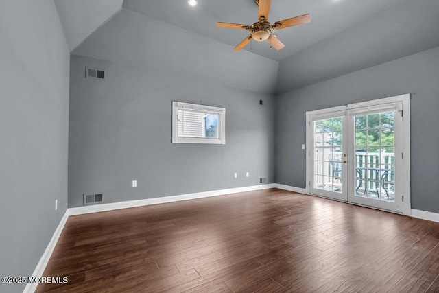 empty room featuring ceiling fan, visible vents, wood finished floors, and lofted ceiling