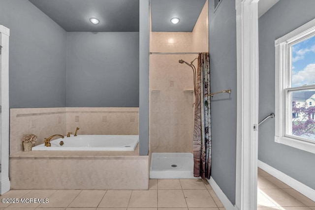 bathroom with tile patterned floors, a stall shower, and a garden tub