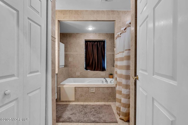 bathroom featuring tiled bath, a shower with curtain, and tile walls