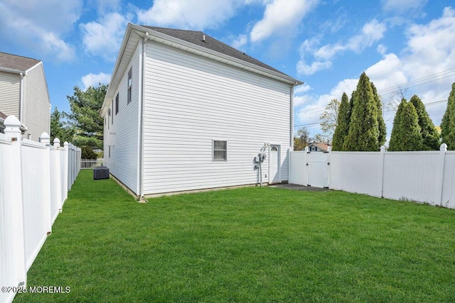 view of home's exterior with a yard, cooling unit, a gate, and a fenced backyard