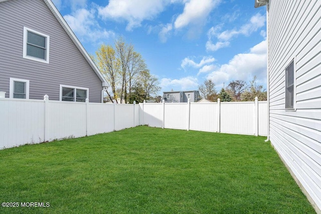 view of yard with a fenced backyard