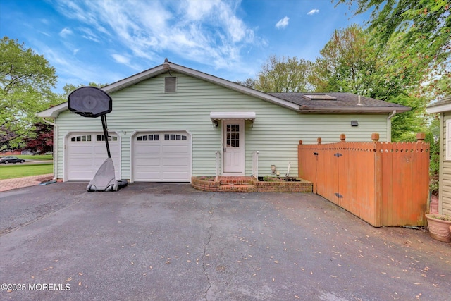 159 Koster Dr, Freehold, NJ 07728 - view of front of home featuring driveway, an attached garage, and fence