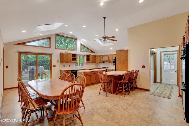 159 Koster Dr, Freehold, NJ 07728 - dining room featuring high vaulted ceiling, plenty of natural light, baseboards, ceiling fan, and a skylight