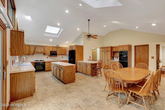 159 Koster Dr, Freehold, NJ 07728 - kitchen featuring a skylight, a sink, black appliances, a kitchen island, and light countertops