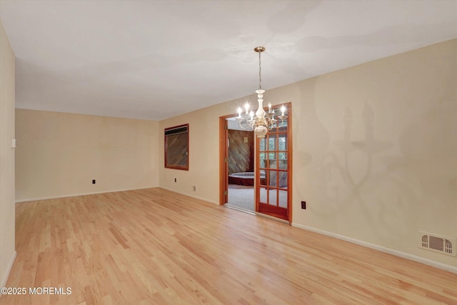 159 Koster Dr, Freehold, NJ 07728 - unfurnished room with light wood-type flooring, a chandelier, and baseboards