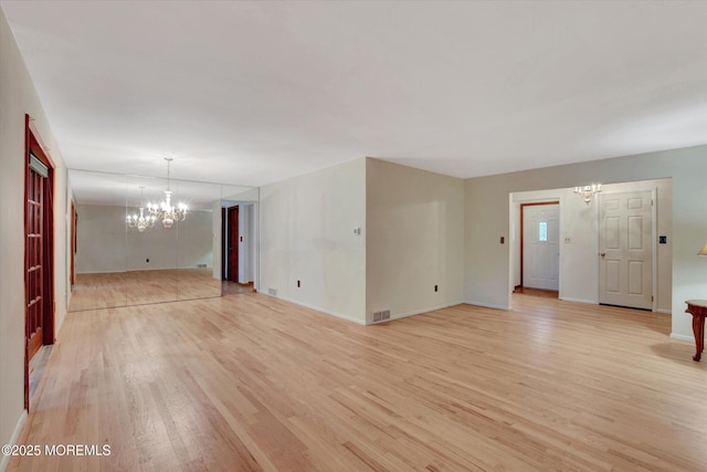 159 Koster Dr, Freehold, NJ 07728 - unfurnished room featuring a chandelier, light wood-style floors, and baseboards