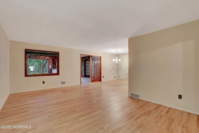 159 Koster Dr, Freehold, NJ 07728 - spare room featuring a chandelier, light wood-style floors, and baseboards