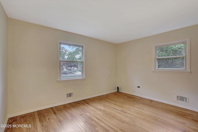 159 Koster Dr, Freehold, NJ 07728 - empty room featuring healthy amount of natural light, light wood-type flooring, and baseboards