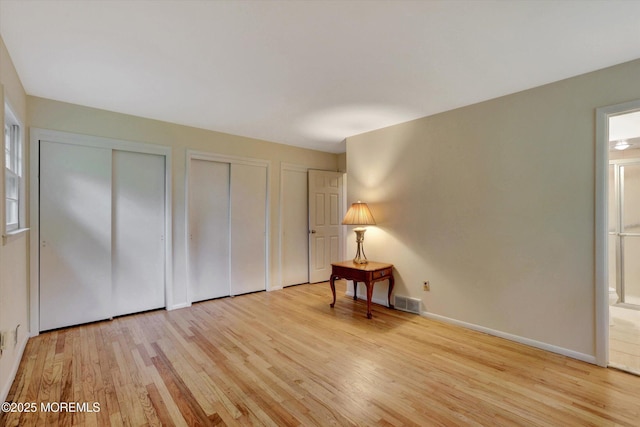 159 Koster Dr, Freehold, NJ 07728 - unfurnished bedroom featuring two closets, light wood-style floors, connected bathroom, and baseboards
