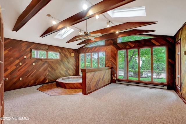 159 Koster Dr, Freehold, NJ 07728 - unfurnished bedroom featuring a skylight, wood walls, a baseboard radiator, carpet, and rail lighting