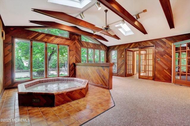 159 Koster Dr, Freehold, NJ 07728 - tiled living area with a skylight, wooden walls, rail lighting, and ceiling fan