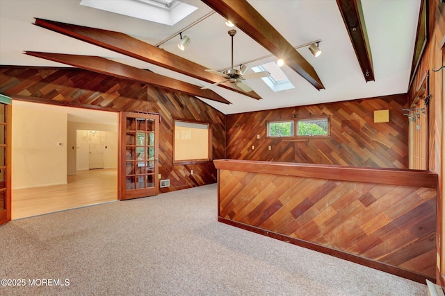 159 Koster Dr, Freehold, NJ 07728 - bar featuring a skylight, track lighting, wood walls, carpet flooring, and ceiling fan