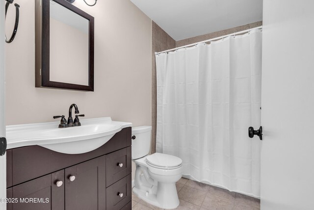 full bath with tile patterned flooring, toilet, vanity, and curtained shower