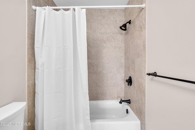 full bathroom with shower / bathtub combination with curtain and toilet