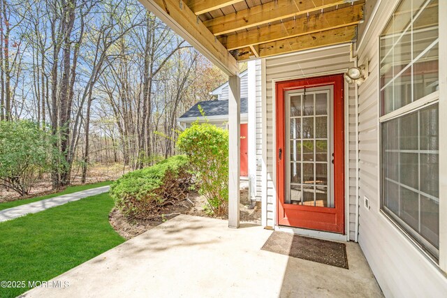 view of exterior entry featuring a patio