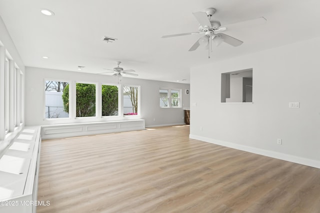 unfurnished living room with ceiling fan, recessed lighting, light wood-style flooring, and baseboards